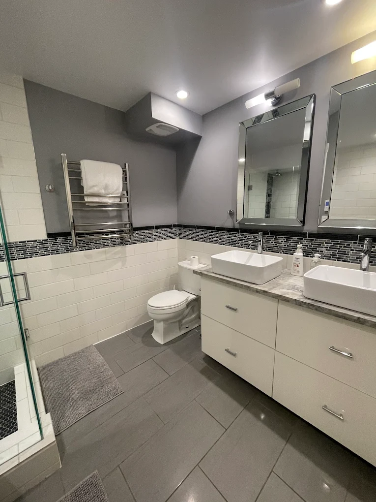 Sparkling bathroom with polished tile, mirrors, and fixtures after a Pride Care cleaning