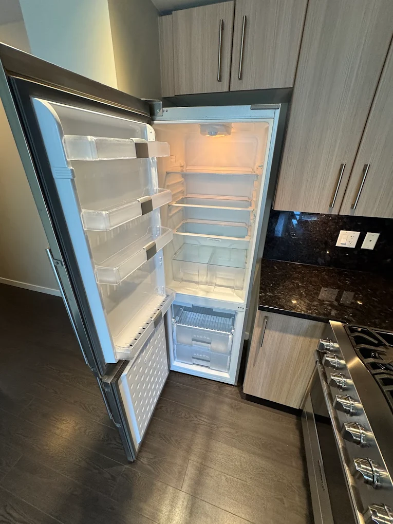Empty, freshly sanitized refrigerator interior after a Pride Care move-out clean