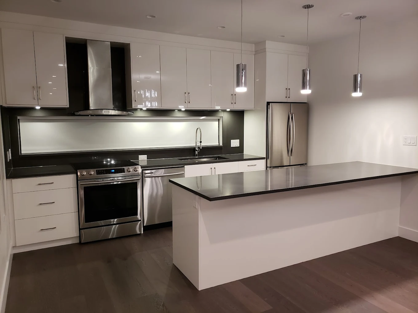 Spotless modern kitchen with polished stainless appliances after a Pride Care deep clean