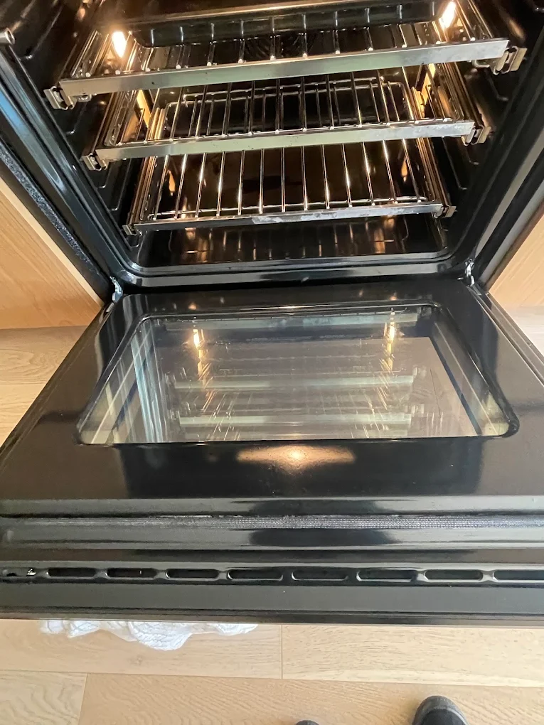 Oven interior with degreased racks and streak-free glass door after a Pride Care Cleaning deep clean
